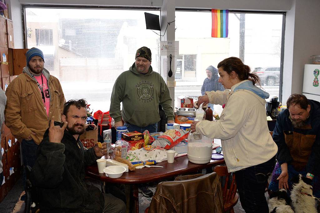 (Louis Krauss | Grays Harbor News Group) From left, Greg Sanchez, Josh Francis, Phil Calloway, Liz Aitken and Jim Traversie sit inside Revival of Grays Harbors shelter, where 24 people have been sleeping overnight during the snow storm.