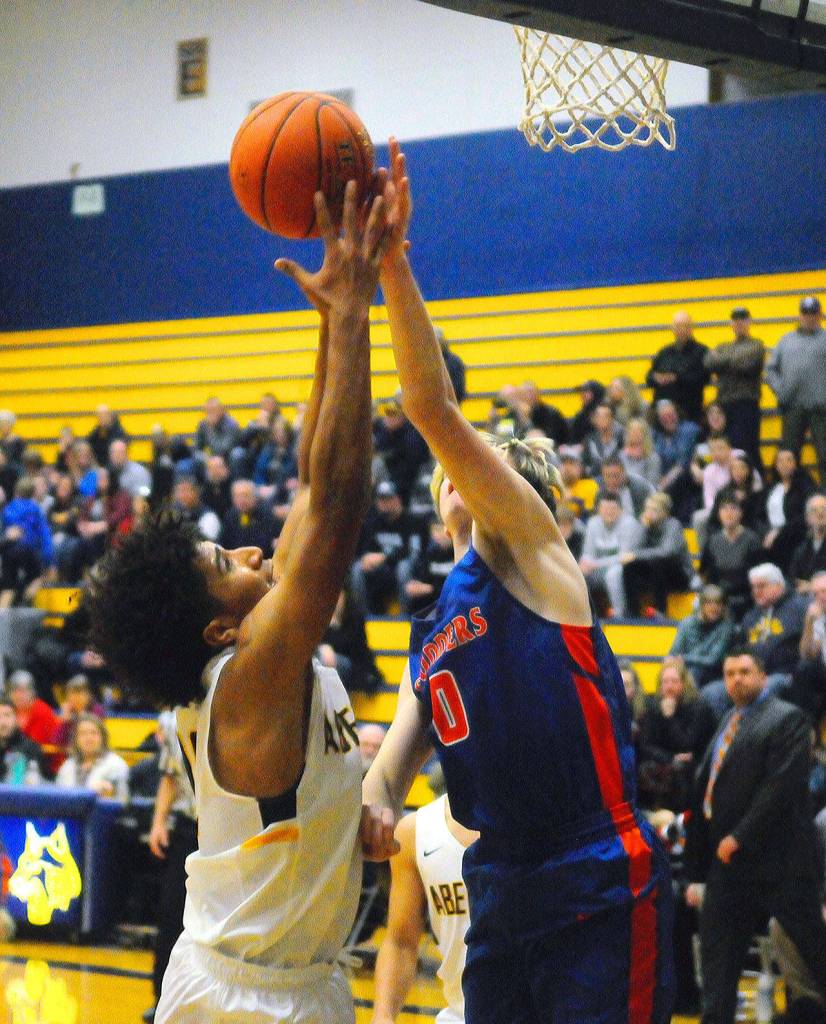 Aberdeens Derrell Shale battles for a rebound with Ridgefields Carson Knight in the third quarter on Tuesday night. (Hasani Grayson | Grays Harbor News Group)