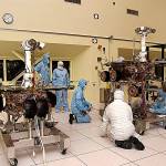 JPL engineers make adjustments to Spirit. At left is its twin, Opportunity. (Jet Propulsion Laboratory)