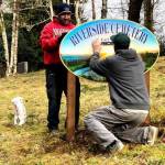 Coastline employees Rene Cisneros and Jonathan Evers place the new sign. The sign was designed and printed by Coastline Signs owner Scott Lowe. (Deborah Sturgill)