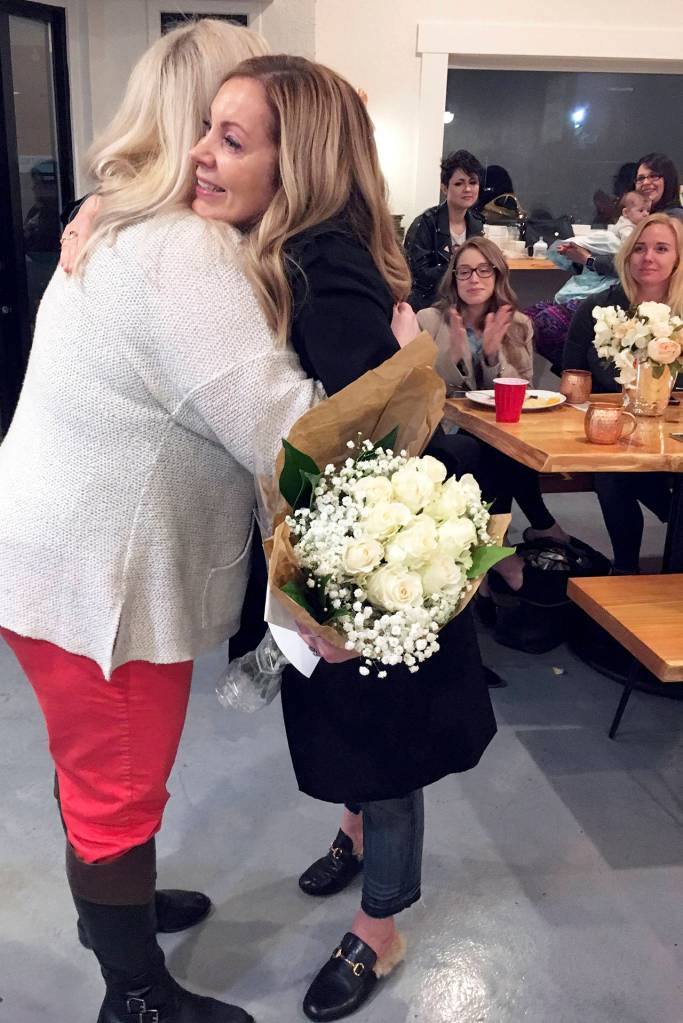 (Kat Bryant | Grays Harbor News Group) Hoquiam Mayor Jasmine Dickhoff, left, hugs Jill Smith after honoring her with the inaugural Female Empowerment Award.
