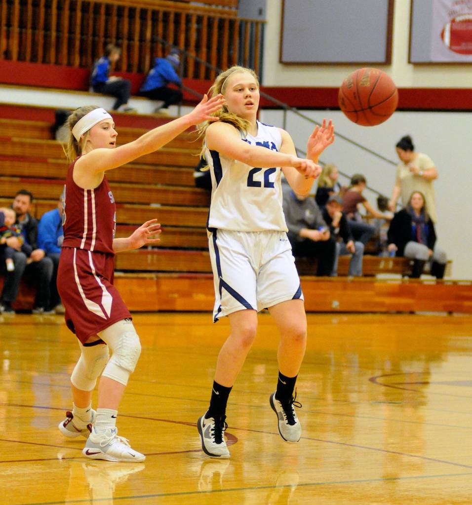 Elmas Quin Mikel, right, passes the ball while being defended by Stevensons Katie Rathgeber during the Eagles 1A District IV semifinal win over the Stevenson Bulldogs on Friday. (Ryan Sparks | Grays Harbor News Group)