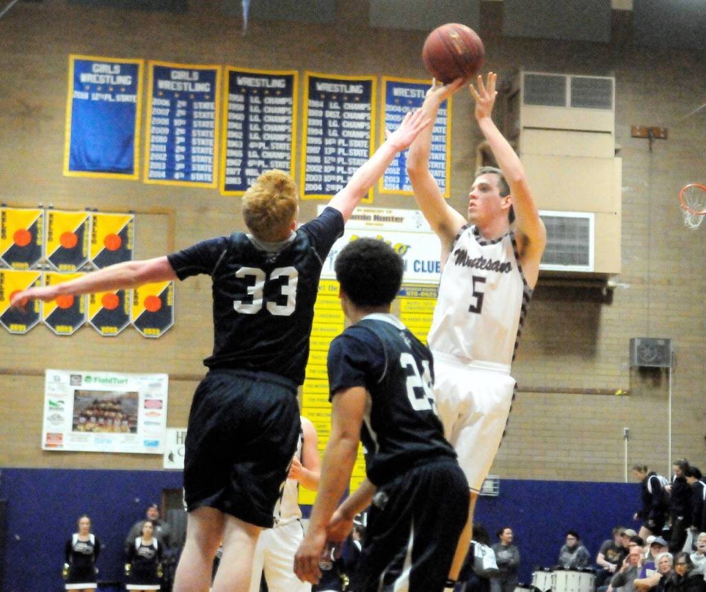 Montesanos Evan Bates take a 3-point shot over Seton Catholics Andrew Olson in the third quarter on Saturday. (Hasani Grayson | Grays Harbor News Group)