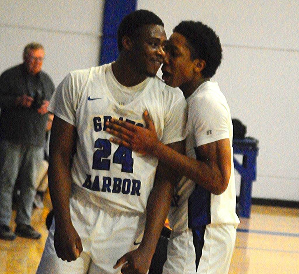 Grays Harbors Zyare Ruffin, left, celebrates with teammate Michael Sampson after Ruffin hit a layup while drawing a foul on the play. Ruffin led the Chokers with 19 points in their 65-51 win over Tacoma on Wednesday. (Hasani Grayson | Grays Harbor News Group)