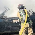 COURTESY HOQUIAM POLICE DEPARTMENT Hoquiam firefighters extinguished a fully involved car fire in an alley behind an apartment complex in the 2500 block of Sumner Avenue Friday morning.