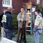(Photo courtesy Malchert family) Joseph Malchert, center, talks with volunteers (including his twin, Daniel, far left) about mounting the rifle display at the World War I memorial in Montesano.