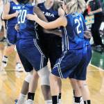 Jillian Bieker, middle, is congratulated by her teammates after hitting two free throws to give her team the lead in overtime against Meridian on Friday. (Hasani Grayson | Grays Harbor News Group)