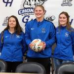 Ocosta High Schools Kristi Raffelson, center, and Mercedes Denny, right, stand along side former Ocosta player and current Grays Harbor midfielder Adrianna Huerta after a signing ceremony at Grays Harbor College on Thursday. (Ryan Sparks | Grays Harbor News Group)
