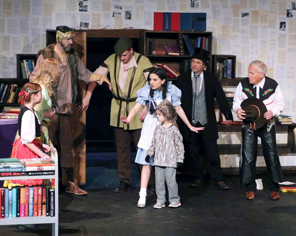 Photos by Keith J. Krueger                                <strong>ABOVE:</strong> A moment in time, from left: Heidi (Emily Mefford), Margie (Mikaela Murphy), Frankenstein (David Quigg), Robin Hood (Zack Underwood), Dorothy (Alena Membreño), Toto (Aubriel Muñoz), Dr. Doolittle (Jeff Ryser) and Hopalong Cassidy (Dave Foscue).                                <strong>RIGHT: </strong>Officer Ketchum (played by Aiden Brown) talks with Margie, the shop owner (Mikaela Murphy), and her cat, Bombalurina (Rinzy Hunt).