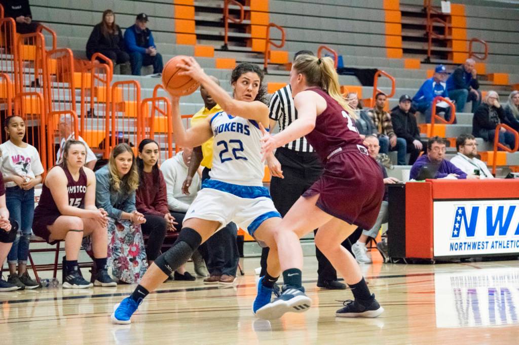 Isabel Hernandez (22) of Grays Harbor dribbles against a Whatcom Community College defender in the Sweet Sixteen of the NWAC Womens Basketball Championship tournament in Everett, Wash. on Saturday, March 9. (Katie Webber | The Herald)