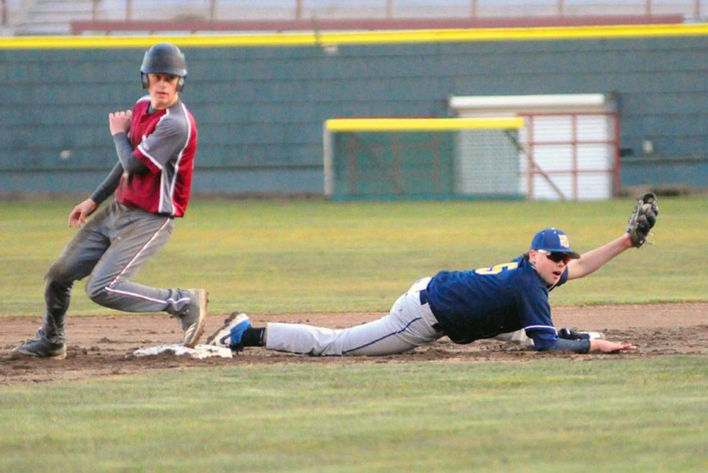 Aberdeens Tyler Williamson holds up his glove to the show the umpire the ball after a close play at second involving Hoquiams Zach Cook in the second inning. (Hasani Grayson | Grays Harbor News Group)