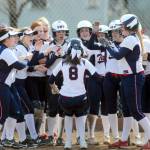 PWV players surround Katelyn McGough (8) after she belted a grand slam home run in the second game of a doubleheader against Raymond on Saturday. (Ryan Sparks | Grays Harbor News Group)