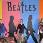 DAN HAMMOCK | GRAYS HARBOR NEWS GROUP                                Westport artist Nina Yates, center, blends into her mural of The Beatles with fellow artist Kemi Strode, left, and RocknBrews owner Cindy Perry. Yates blended the iconic Abbey Road album cover with background colors based on pop artist Andy Warhols cover for the 1980 book, The Beatles, to create the mural.