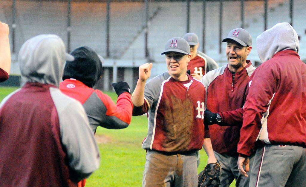 Hoquiams Jackson Folkers celebrates with teammates and coaches after picking up the final out of the game. (Hasani Grayson | Grays Harbor News Group)