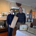 Louis Krauss | Grays Harbor News Group                                Australian Professor Chris Gibson, left, stands with Polson Museum Director John Larson holding wood from the Posey Manufacturing Co. for a guitar soundboard.