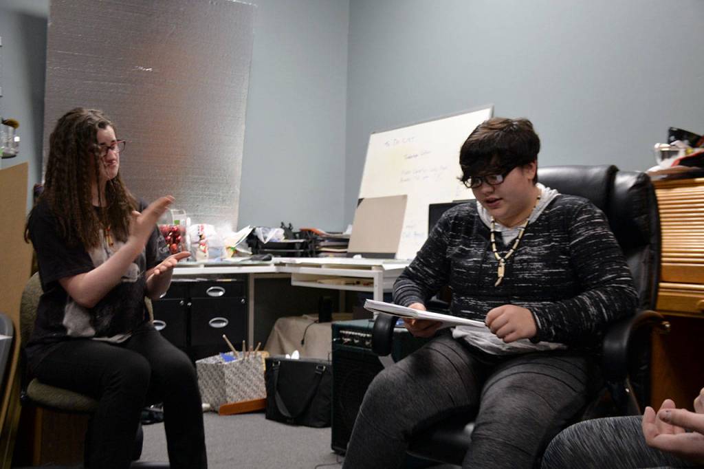 Teyah Johnson, left, practices her sign language while Eren Swift sings at the Bridge Music Project rehearsal.