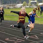 South Bends Hannah Byington, left, edges Willapa Valleys Brooke Friese to win the girls 100 meter sprint at the Henrie-Weisel Tri-District meet on Thursday at Raymond High School. (Photo by Larry Bale)