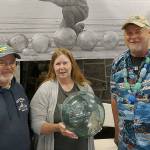 COURTESY WESTPORT SOUTH BEACH HISTORICAL SOCIETY                                A drawing for a premium 16-inch Japanese glass fishing float like this one will be held Saturday at noon during the Whale of a Sale at McCausland Hall. Terri Branson-Varga found this float and took it to the Grayland Driftwood Show on March 31 to show to beachcombing experts Alan Rammer, left, and John Anderson.