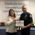(Courtesy April Heikkila | Grays Harbor News Group) Sarah Oleachea, a member of the Harbor Strong coalition and an Aberdeen High School student parent, presents Aberdeen Police Chief Steve Shumate a certificate of appreciation for efforts to reduce unused prescription medications in Aberdeen.