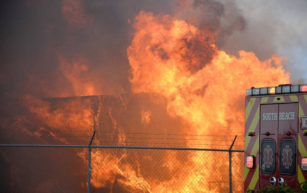 DAN HAMMOCK | GRAYS HARBOR NEWS GROUP                                Flames consume the Coast Seafood processing plant off State Route 105 behind the Ocean Spray plant Tuesday afternoon.
