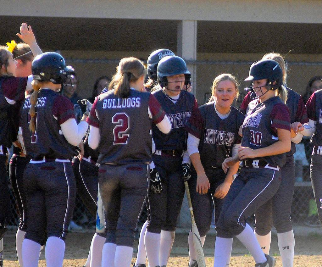 Montesanos Lindsay Pace (20) is greeted at home plate by her teammates after hitting a home run in the third inning against Elma. (Hasani Grayson | Grays Harbor News Group)