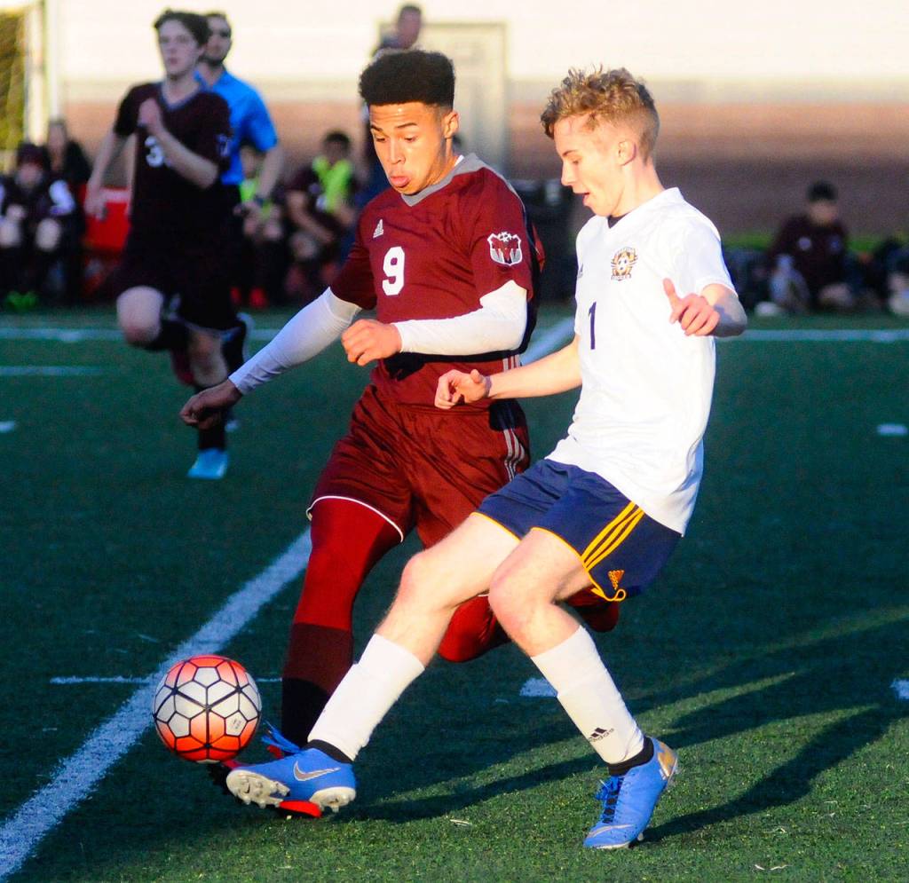 Montesanos Yemi Idowu battles for the ball with Forks Seth Johnson in the first half on Wednesday. (Hasani Grayson | Grays Harbor News Group)