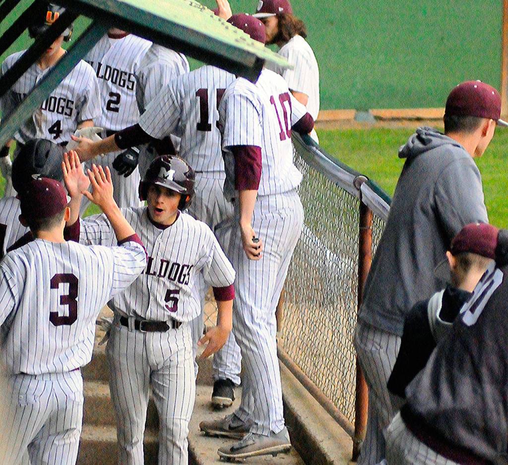 Montesanos Parker Plato (5) celebrates with Braden Dohrmann (5) after scoring a run in a game against Hoiquiam on Thursday. (Hasani Grayson | Grays Harbor News Group)