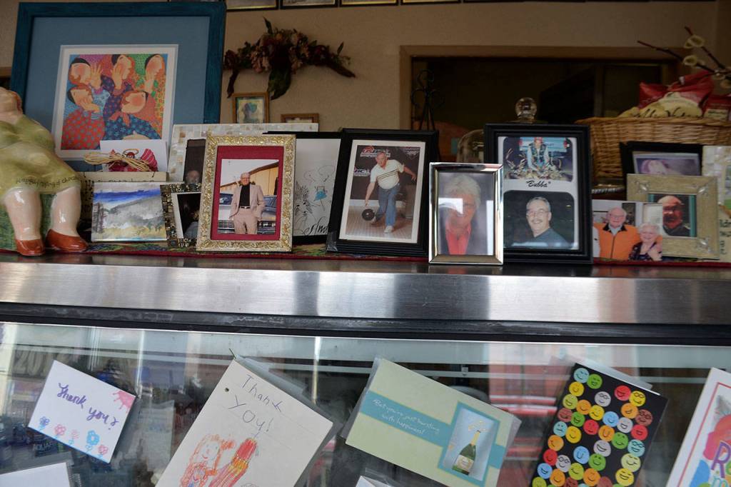 The counter at Anne Maries Cafe showcases some portraits of longtime customers and family, some of whom have passed away. Below are some thank you cards to commemorate Anne Marie Babineaus retirement and the cafes closure.