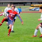 Hoquiam forward Skyler Johnson (2) controls a bouncing ball while defended by Montesanos Yemi Idowu in the second half on Friday. Johnson scored the first goal of the match in the Grizzlies 2-0 win over the Bulldogs. (Hasani Grayson | Grays Harbor News Group)