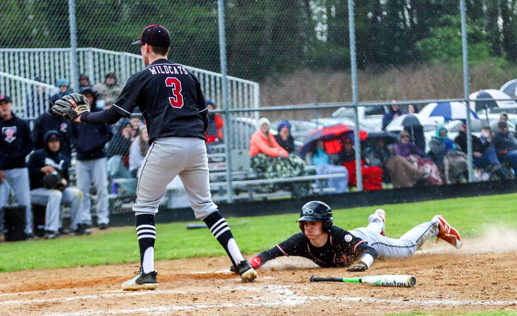 Raymonds McCartney Maden slides in safely during the second game of a doubleheader against Ocosta on Saturday in Raymond. (Photo by Larry Bale)