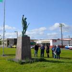 (Louis Krauss | Grays Harbor News Group) Aberdeen city staff and directors of the Aberdeen Museum of History look at the Doughboy statue, which was returned to Zelasko Park after repairs.