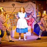 (Scott D. Johnston | Grays Harbor News Group) In a scene from the Stage West Community Theatre production of Alice in Wonderland, Alice (Joni Chism) finds herself in the middle as Tweedledee (Pamela Nygaard on right) and Tweedledum (Cai Hadfield) prepare for battle with brooms, buckets and washboards.