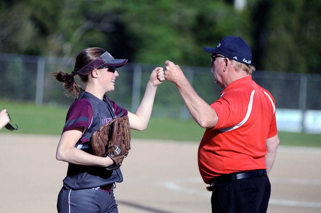 In an example of good sportsmanship, Montesano left fielder Matti Ekerson, left, gets a fist bump from PWV head coach Ken Olson after Ekerson made a leaping catch on a lined shot by Katelyn McGough in the sixth inning of Mondays game. Ekersons play prevented the tying and go-ahead runs from scoring. (Ryan Sparks | Grays Harbor News Group)