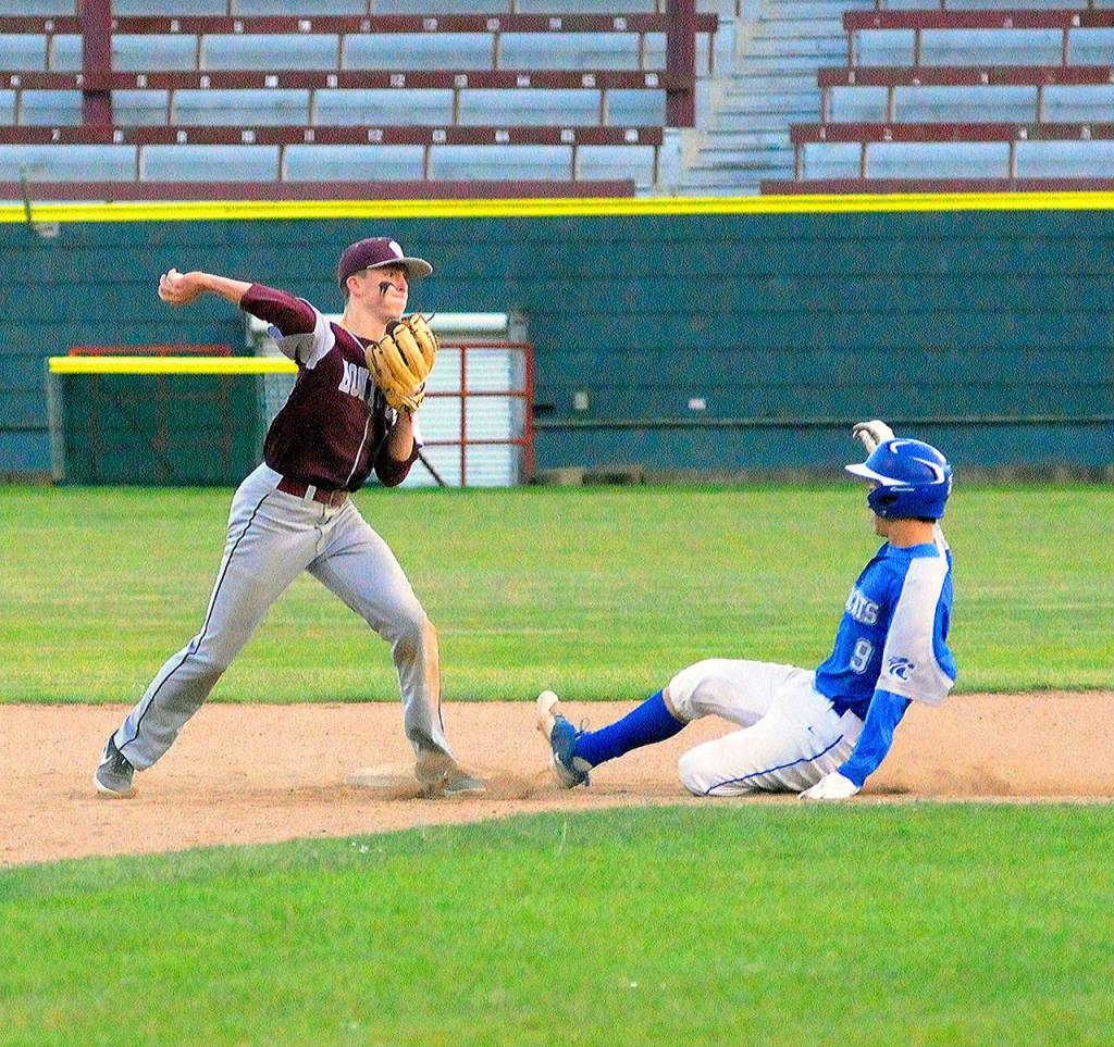 Montesano second basemen Braden Dohrmann gets La Centers Michael Goode out at second base and throws to first to complete the double play on Tuesday at Olympic Stadium. (Hasani Grayson | Grays Harbor Newsgroup)