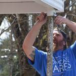 Volunteer AJ Andrade helps repair a post May 4 at the McCleary VFW post as part of Comcast Corp.s Comcast Cares Day. A post leader said about 200 people showed up to do work around the building. (Photo courtesy Comcast Corp.)
