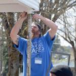 Volunteer AJ Andrade helps repair a post May 4 at the McCleary VFW post as part of Comcast Corp.s Comcast Cares Day. A post leader said about 200 people showed up to do work around the building. (Photo courtesy Comcast Corp.)