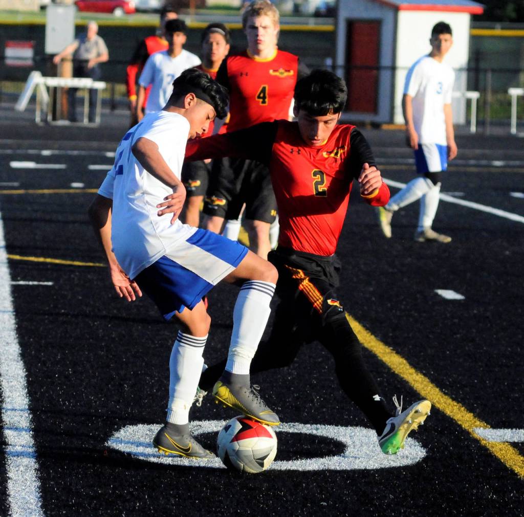 Elmas Alexis Bautista, left, dribbles around Eucario Contreras from Toledo-Winlock in the first half of a game against Toledo-Winlock United. (Hasani Grayson | Grays Harbor News Group)