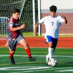 Elmas Rodrigo Luna runs down the sidelines while Hoquiams Andy Garcia tries to chase him down in the second half on Friday. (Hasani Grayson | Grays Harbor News Group)
