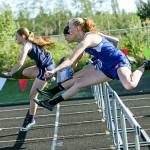 Ilwacos Elizabeth McMullen, left, leads Willapa Valleys Hannah Cook, foreground, and Brooke Friese during the girls 100-meter hurdles at the Pacific League Sub-District Finals on Friday. (Photo by Larry Bale)