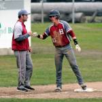 Hoquiams Troy McMinn, right, gets a fist bump from head coach Steve Jump after McMinn hit a triple in the fourth inning of Saturdays district title game against the Montesano Bulldogs. (Ryan Sparks | Grays Harbor News Group)