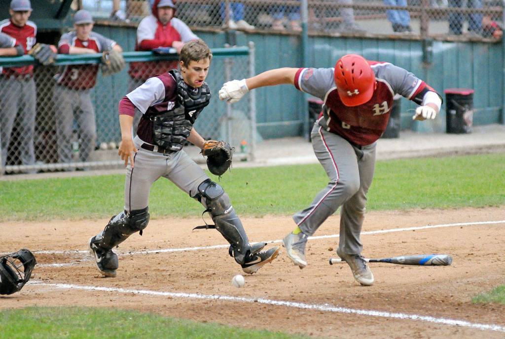 Hoquiams Payton Quintanilla, right, tries to avoid the ball after hitting a chopper in front of home plate while Monte catcher Parker Plato defends during the fourth inning of Saturdayd 1A District IV championship game. Quintanilla was called out for offensive interference on the play. (Ryan Sparks | Grays Harbor News Group)