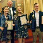 Courtesy photo                                Buckley Strong, school awards chairman for Wynooche Masonic Lodge #43, presents scholarships to Kaylee Sowle, left, of Mary M. Knight High School, Molly Johnston of Elma High School, and Evan Bates of Montesano High School.