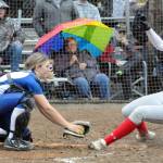 Elma catcher Olivia Cain, left, tags out a Castle Rock runner during the fourth inning of Elmas 3-1 rain-shortened loss in the 1A District IV Tournament on Wednesday at Borst Park in Centralia. (Hasani Grayson | Grays Harbor News Group)