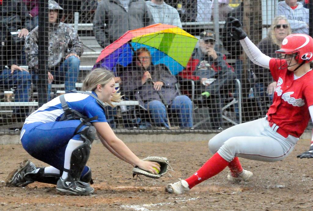 Elma catcher Olivia Cain, left, tags out a Castle Rock runner during the fourth inning of Elmas 3-1 rain-shortened loss in the 1A District IV Tournament on Wednesday at Borst Park in Centralia. (Hasani Grayson | Grays Harbor News Group)