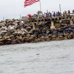 Brandy Evans                                The wreath floats near the silent crowd gathered at the Fishermens Memorial during the 2017 ceremony.