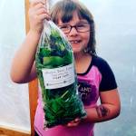 Courtesy Harbor Eden Farms                                Ares Ross, daughter of the owners of Harbor Eden Farms which will be at this Sundays Aberdeen farmers market, holds up a bag of the farms Power Greens mix.