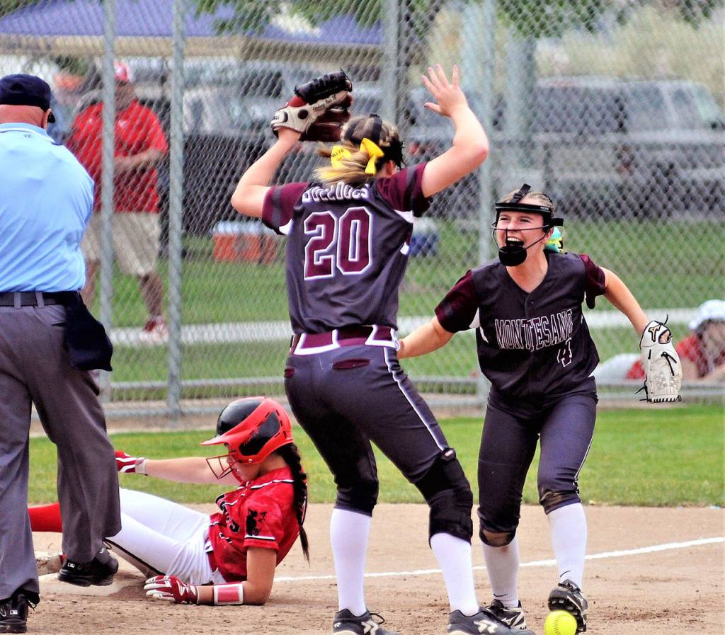 Montesaos Payton Kersker (4) celebrates with Lindsay Pace after tagging a runner out at third to the end the second inning against Coupeville on Friday. (Hasani Grayson | Grays Harbor News Group)