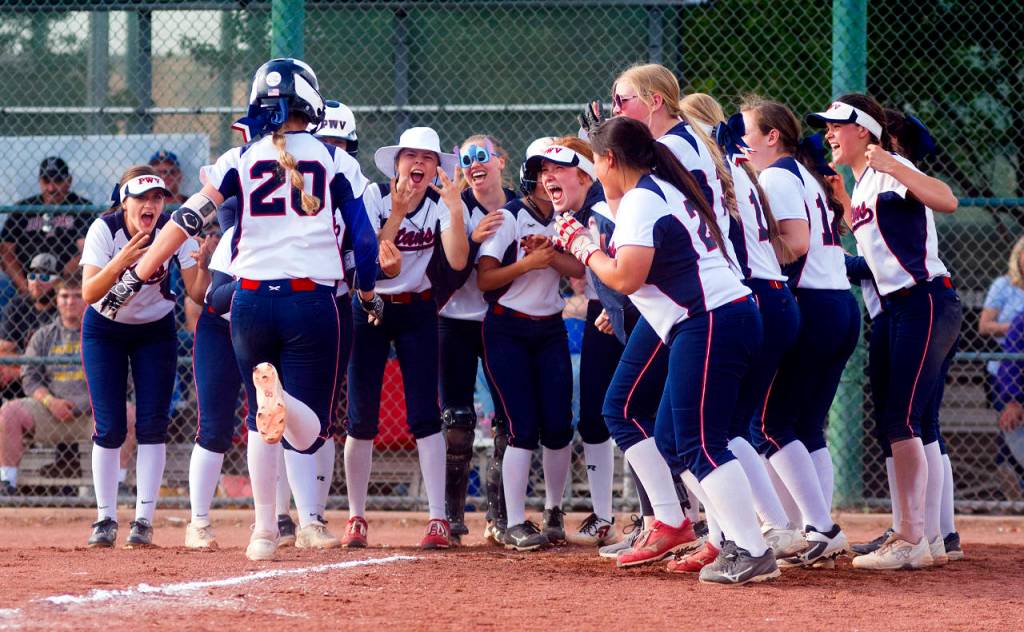 The PWV Titans await the arrival of Britney Patrick (20) after the third baseman belted a two-run home run in the third inning of Saturdays 2B State title game. (Photo by Matt Baide | The Chronicle)