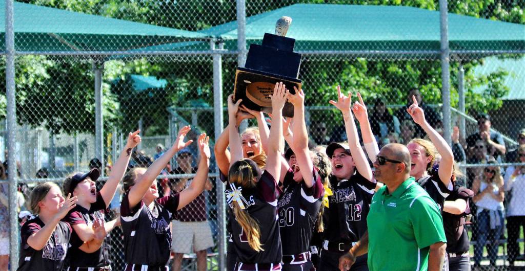 The Montesano Bulldogs celebrate after being presented the 1A State softball championship trophy after beating Castle Rock 5-4 on Saturday at the Columbia Playfield in Richland. (Hasani Grayson | Grays Harbor News Group)