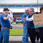 Scott D. Johnston | Grays Harbor News Group                                Ocean Shores City Council member Jon Martin (in blue vest) speaks with roadside weed spraying protesters as Council candidate Chuck Anderson holds up a sign.